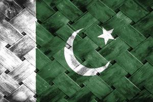 pakistan flag screen on wicker wood background photo