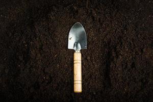 Gardening equipment and hand with soil photo