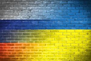 Ukraine and russia Flag on brick wall diplomatic relations between Ukraine and russia. Flag of the two countries concept Ukraine Russia conflict photo