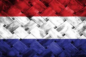 netherlands flag screen on wicker wood background photo