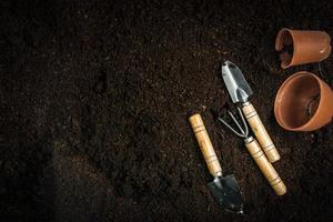 Gardening equipment and hand with soil photo