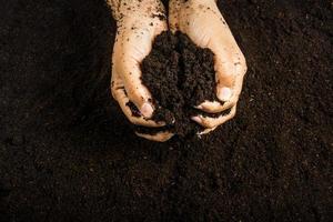 Hands dirty with clay , soil background photo