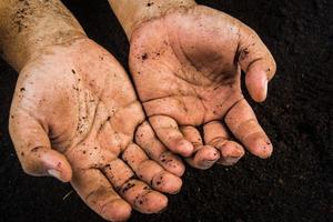 Hands dirty with clay , soil background photo