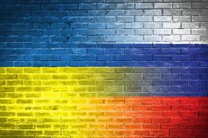 Ukraine and russia Flag on brick wall diplomatic relations between Ukraine and russia. Flag of the two countries concept Ukraine Russia conflict photo