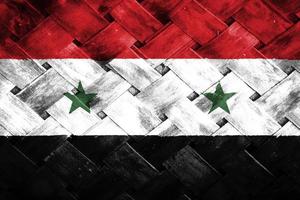 Pantalla de bandera siria sobre fondo de madera de mimbre foto