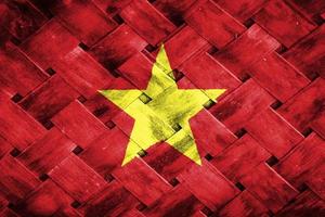 vietnam flag screen on wicker wood background photo