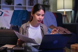 Cheerful beautiful Asian woman using digital laptop at video calling meeting and study online on the Internet. photo