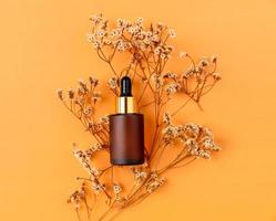 Top view of cosmetic bottle cream mockup, Blank label package on orange background. photo