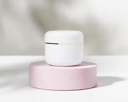 White cosmetic bottle on podium, ingredients for skin care and treatment vitamin, packaging product for mockup. photo