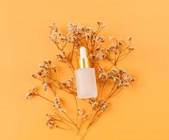 Top view of cosmetic bottle cream mockup, Blank label package on orange background. photo
