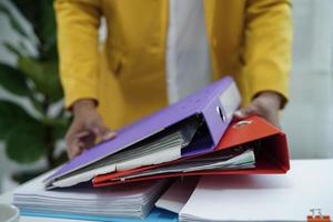 Businessman working and prepare paperwork report data to analysis information in file binder at office. photo