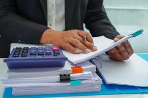 Businessman working and prepare paperwork report data to analysis information in file binder at office. photo