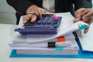 Businessman working and prepare paperwork report data to analysis information in file binder at office. photo