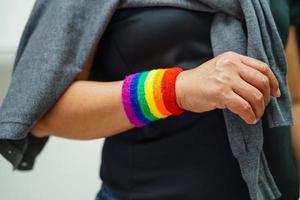 Asian woman with rainbow flag, LGBT symbol rights and gender equality, LGBT Pride Month in June. photo