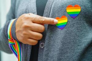 Asian woman with rainbow flag, LGBT symbol rights and gender equality, LGBT Pride Month in June. photo