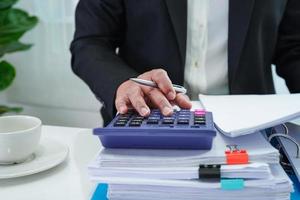 Businessman working and prepare paperwork report data to analysis information in file binder at office. photo