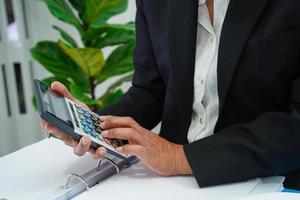 Businessman working and prepare paperwork report data to analysis information in file binder at office. photo