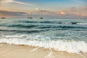Beautiful beach with very clean and azure water on the mediterranean sea in the island of Ibiza, Spain. photo