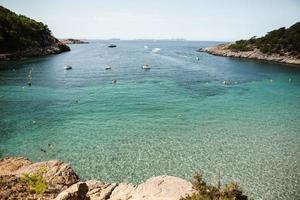 Beautiful beach with very clean and azure water on the mediterranean sea in the island of Ibiza, Spain photo
