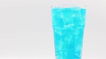 Rotate glass of Blue Hawaii sparkling water drink over white background. video