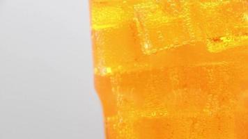 Orange sparkling water with Ice in glass video