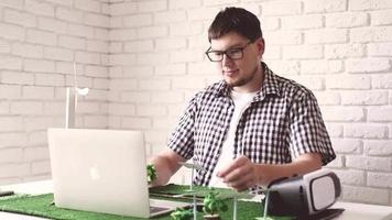 Young man making renewable energy project dummy video