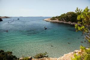 Beautiful beach with very clean and azure water on the mediterranean sea in the island of Ibiza, Spain photo