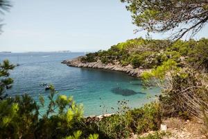 Beautiful beach with very clean and azure water on the mediterranean sea in the island of Ibiza, Spain photo