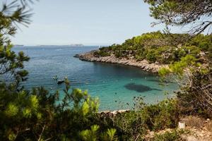 Beautiful beach with very clean and azure water on the mediterranean sea in the island of Ibiza, Spain photo