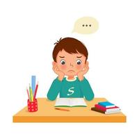 upset little boy with both hands on his cheek feeling tired, bored and lazy studying doing his homework at the desk at home vector