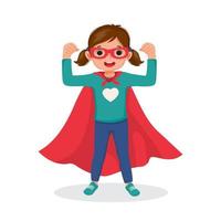 Cute little girl playing dressed in superhero costumes standing raising hands showing her strong arm fists vector