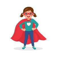 Cute little girl plays wearing superhero costumes standing with hands on her hips pose vector