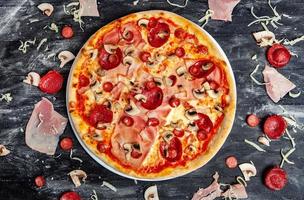 slices of pizza with different toppings on a wooden background. Delicious fresh pizza on white background. photo