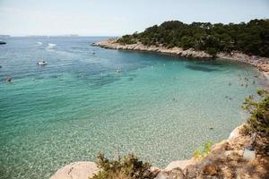 Beautiful beach with very clean and azure water on the mediterranean sea in the island of Ibiza, Spain photo