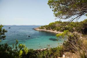 Beautiful beach with very clean and azure water on the mediterranean sea in the island of Ibiza, Spain photo