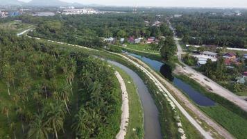 Aerial fly over river near Malays Village with plantation video