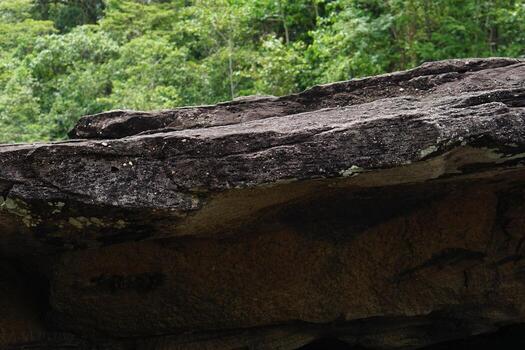 large rock that was eroded by water and wind to form a beautiful pattern. photo