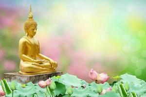 Makha Asanaha Visakha Bucha Day Golden Buddha image. Background of Bodhi leaves with shining light. Soft image and smooth focus style photo