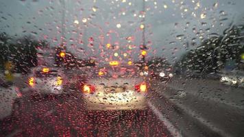 Selective focus rain droplets falling down at windshield video