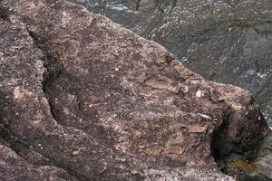 wind stone background. erosion creates a beautiful pattern beside the river. photo