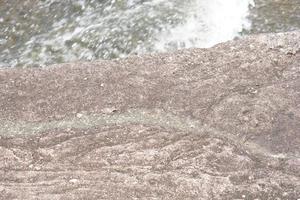 wind stone background. erosion creates a beautiful pattern beside the river. photo