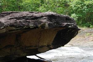 large rock that was eroded by water and wind to form a beautiful pattern. photo