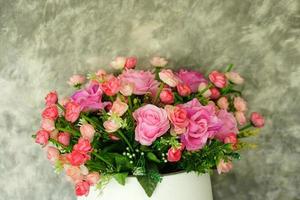 roses in pots cement wall background photo