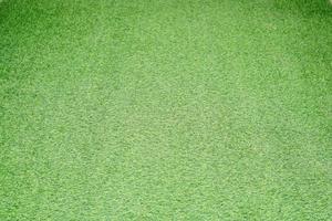 Green artificial grass background is used as a walkway. photo