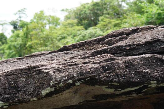 large rock that was eroded by water and wind to form a beautiful pattern. photo
