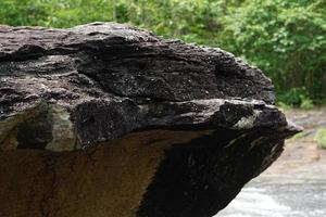 large rock that was eroded by water and wind to form a beautiful pattern. photo