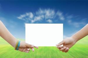 Two children holding a white paper background nature. photo