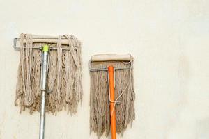 Mop next to the wall of the house photo