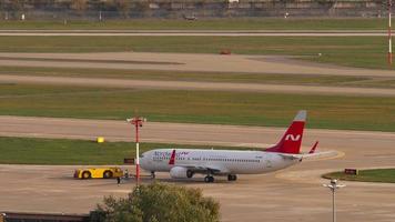 Boeing 737 airliner being towed before departure. video