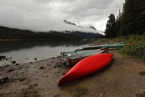 Red canoe, cloudy day photo